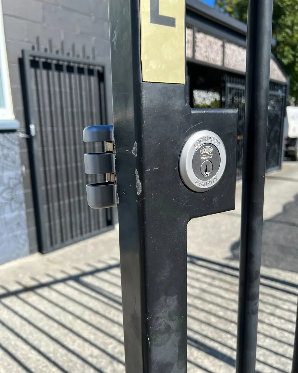 Keyed gate lock on a metal gate